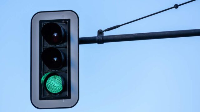 Green traffic light with blue sky (Germany)